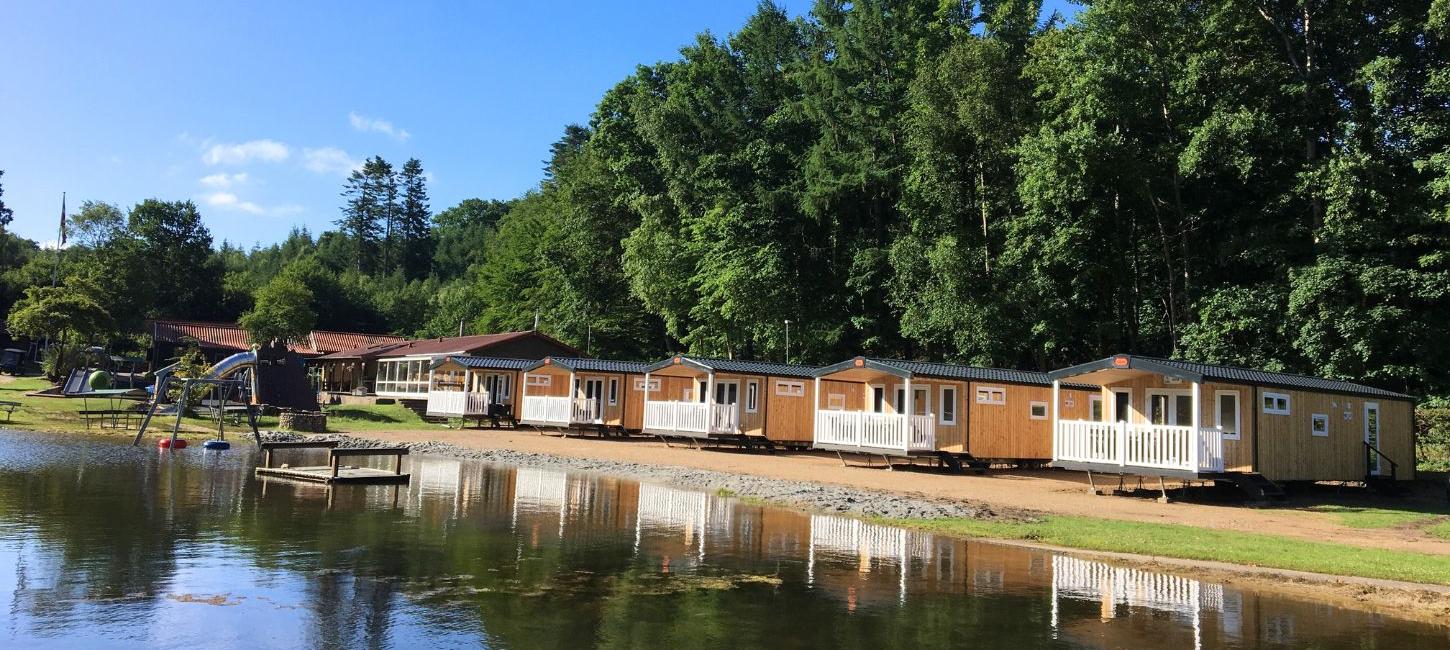 Cabins at Randbøldal Camping by the lake on a summer day