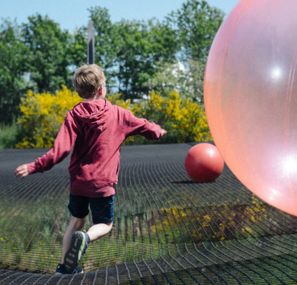 Boy jumps in WOW PARK on big trampoline with big bouncy balls