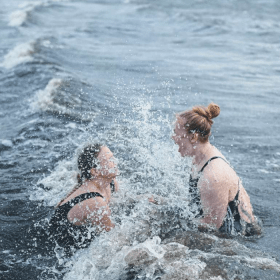 Two women take a winter bath at Tirsbæk Strand