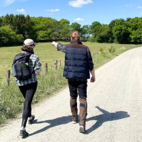  Two people are walking on Hærvejen in the sunshine