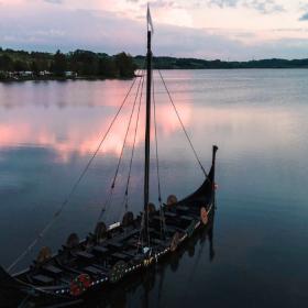 The Viking ship Jelling Orm lies beautifully in Fårup Sø in the summer