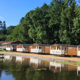 Cabins at Randbøldal Camping by the lake on a summer day